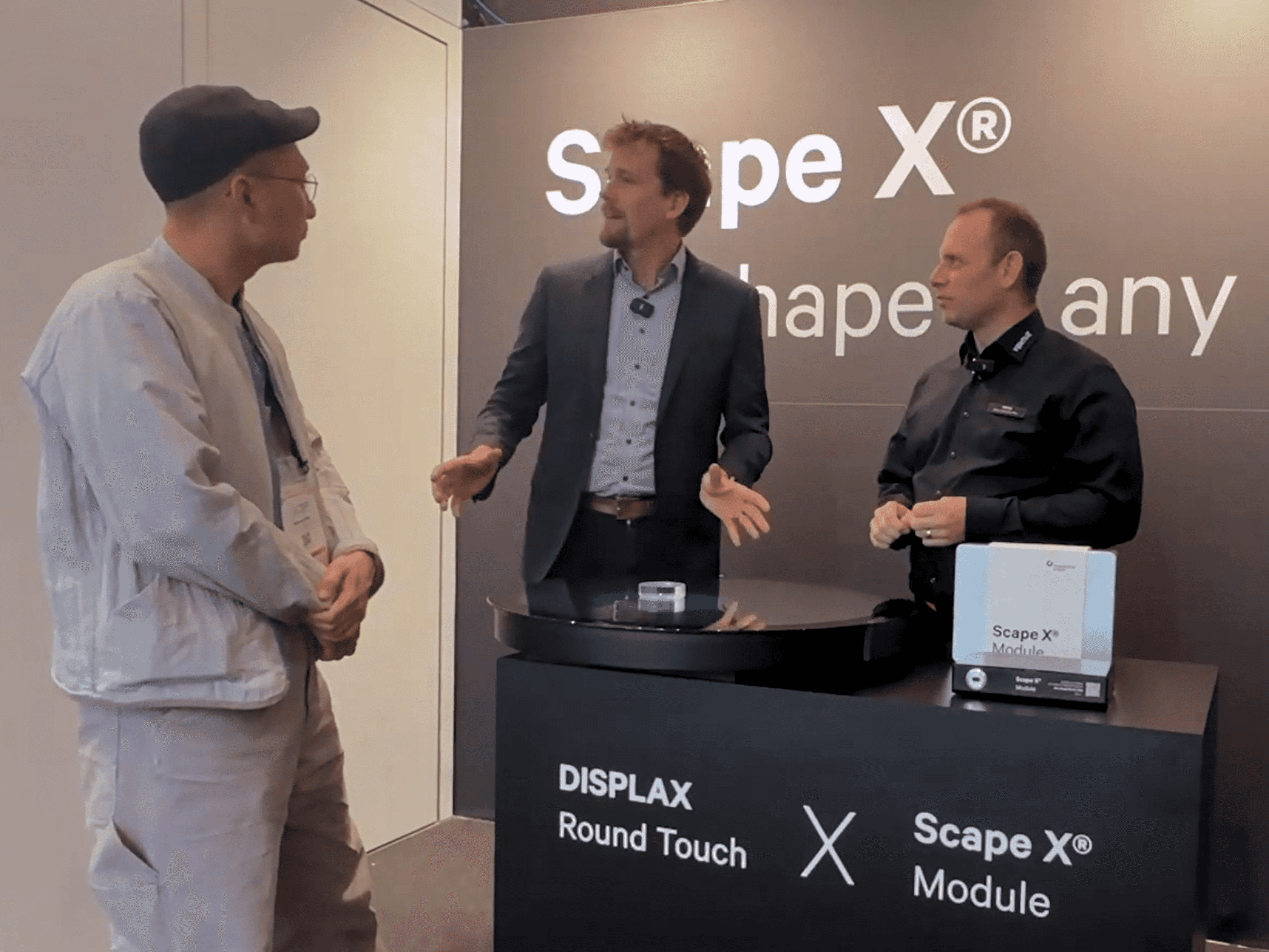 Presenters demonstrate the Scape X Module on a DISPLAX Round Touch display