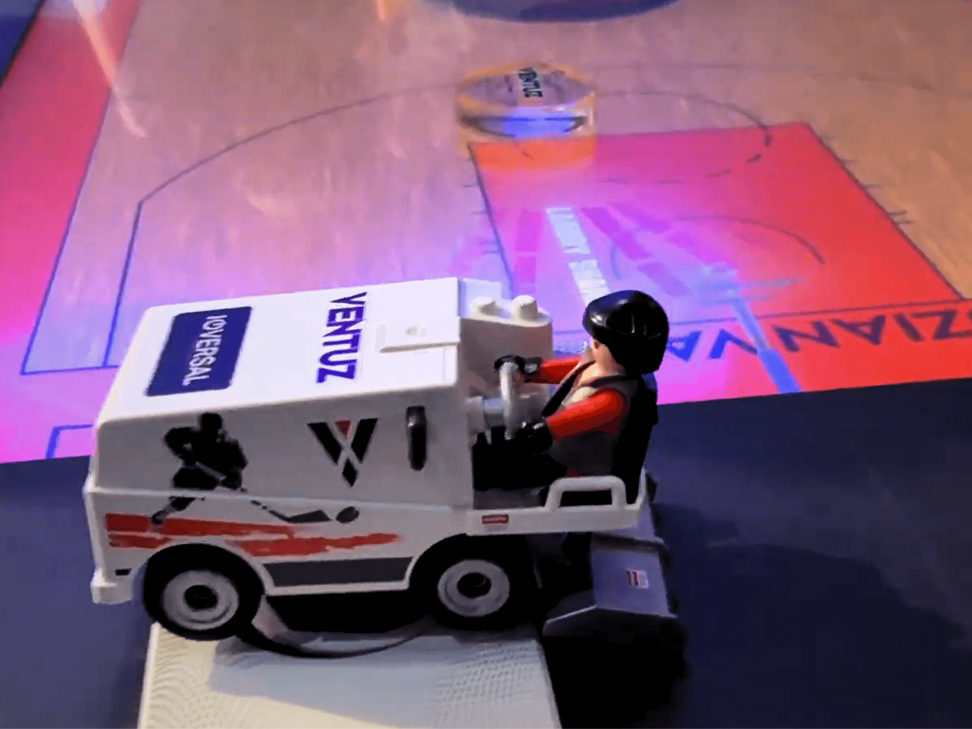 A toy ice resurfacer with Ventuz branding drives across a sports rink rendered in real time on the table